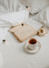 Fototapeta na wymiar coffee and book in the white bed