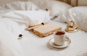 coffee and book in the white bed