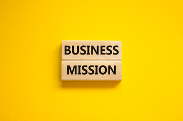 Business success mission symbol. Concept words Business mission on wooden blocks on a beautiful yellow background. Business success mission concept. Copy space.