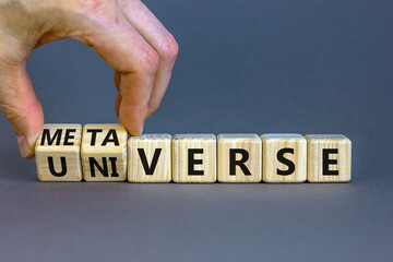 Universe or metaverse symbol. Businessman turns wooden cubes and changes the word universe to...