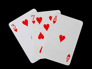 playing cards 3, 7 and ace are fanned out, isolated on a black background