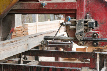 Processing wooden boards at a sawmill. Sawing logs