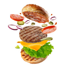 Flying burger. Big tasty hamburger with flying elements.  Explosive cheeseburger. - 471143972