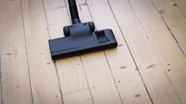 Staubsauger saugt &uuml;ber Holzboden