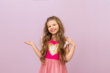 A children with curly hair smiles and flaunts against an isolated background.