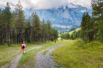 Fototapeta na wymiar Hikers walking on spectacular mountain scenery in Switzerland