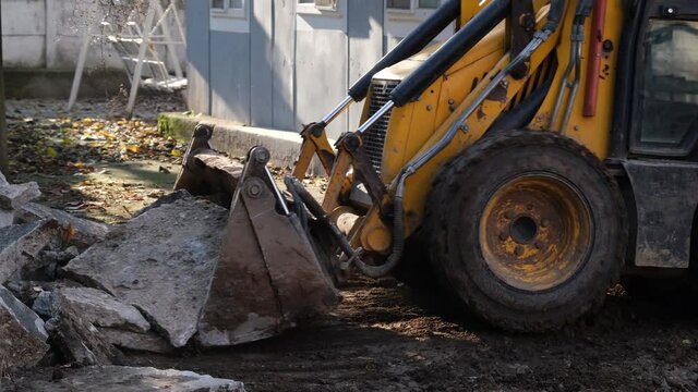 mini dozer, mini dozer lifts concrete blocks, in construction site