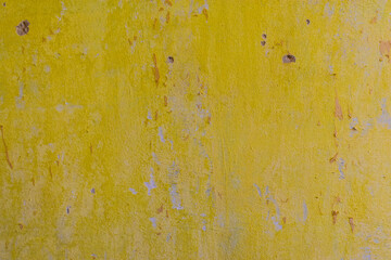 Yellow and Gray Dirty Plaster Wall, With Falling Off Flakes Of Paint. Rough Surface. Peeled Plaster. High quality photo
