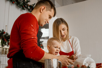 Closeup on face expressions of happy family busy with decorating ginger bisquits