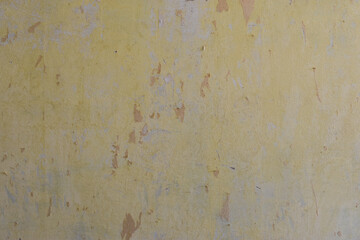 Yellow and Gray Dirty Plaster Wall, With Falling Off Flakes Of Paint. Rough Surface. Peeled Plaster. High quality photo