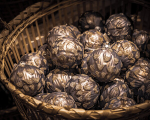 Golden christmas balls in a wicker basket as background. 