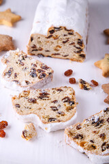 Classical Stollen is a Traditional German Cake with raisins on white background with place for text. Fruit cake for the Holiday.