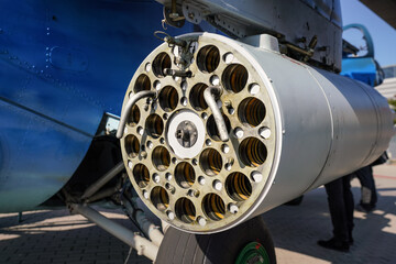 Military combat helicopter side gun or cannon, detail view from behind with tube holes for...