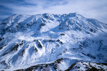 富山県立山町にある立山の冬の雪景色のある風景 Landscape with snowy winter scenery of Tateyama in Tateyama Town, Toyama Prefecture, Japan.