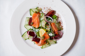 Salmon salad with vegetables. Healthy seafood dish.