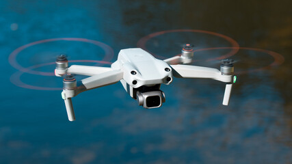 Drone. Professional drone with 5K camera for take a video, photo, film, movie footage. Aerial photography. Helicopter or copter flying over water. Flight technology. Wireless controlled drone.