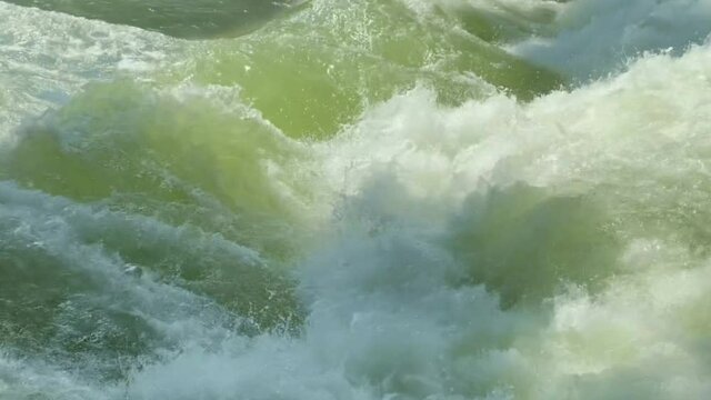 MUNICH, GERMANY. Standing wave on Eisbach river in Munich the best place in the world for urban surfing for professionals. River Surfing place in English Garden. 4K.