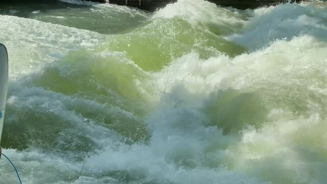 MUNICH, GERMANY. Standing wave on Eisbach river in Munich the best place in the world for urban surfing for professionals. River surfing place in English Garden. HD.