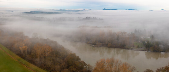 Fog Rolls in Over the Skagit Valley and the Skagit River on a Beautiful Autumn Morning. Aerial drone view of this magnificent area of western Washington state. 