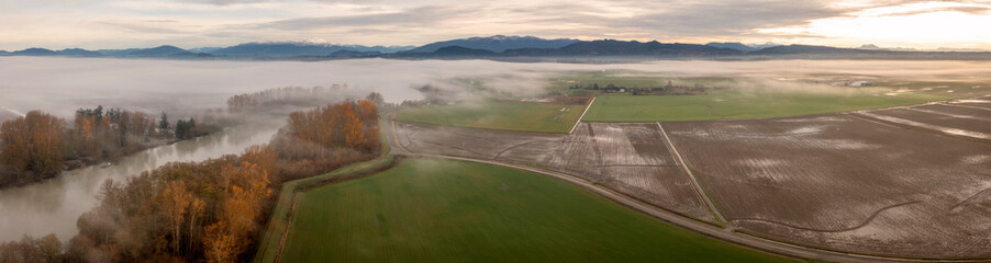 Fog Rolls in Over the Skagit Valley and the Skagit River on a Beautiful Autumn Morning. Aerial drone view of this magnificent area of western Washington state. 