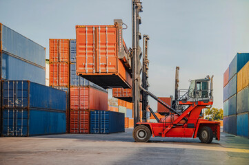 In the shipping industry, a forklift truck raises cargo containers. 