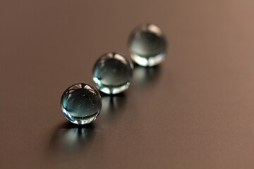 Three Clear Marbles Front Marble in Focus - stock photo.jpg