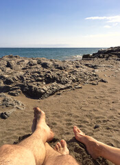 Feet in the sand on the beach