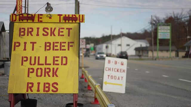 BBQ Chicken sandwich board signs on the side of the road directing hungry customers.