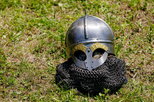 Summer, 2018 - Ussuriysk, Russia - Military-historical reconstruction of the old Russian army. Close-up. The metal helmet lies on the chain mail on the grass.