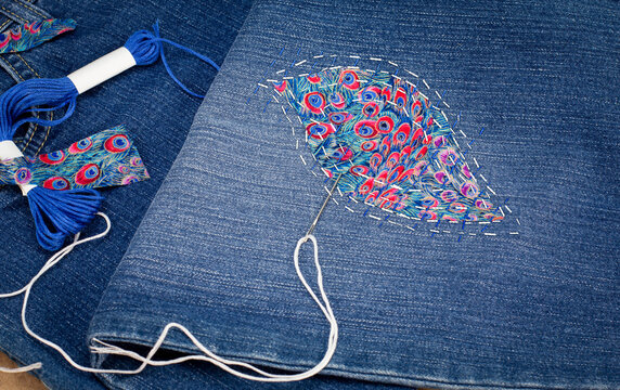 Visible mending on jeans, creative sustainable fashion, repair, mend and recycle. slow fashion make it last.