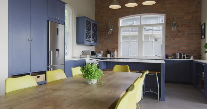 Interior of open plan kitchen and dining room with table and chairs