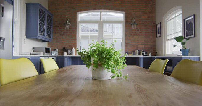 Interior of open plan kitchen and dining room with table and chairs
