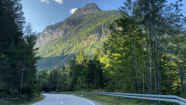 Karwendel mountains in Tirol. Austria. 4K.Shooting through not quite clean car glass