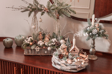 Living room with Christmas decorations on furniture, round decorative wreath, sleigh 