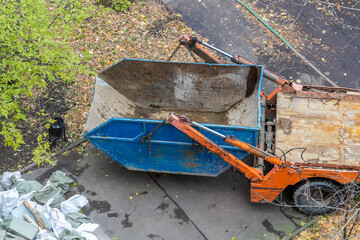 Truck with detachable dumpster. Removal of construction debris by car. Dumpster. Cleaning the city...