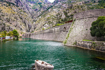River canal near the fortress of the old town of Kotor. Montenegro, Balkans. The mountains.