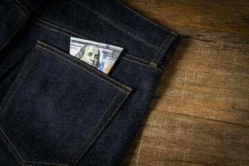 Dollar banknote in a jeans pocket.