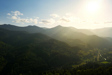 Aerial view of beautiful mountain landscape with forest on sunny day. Drone photography