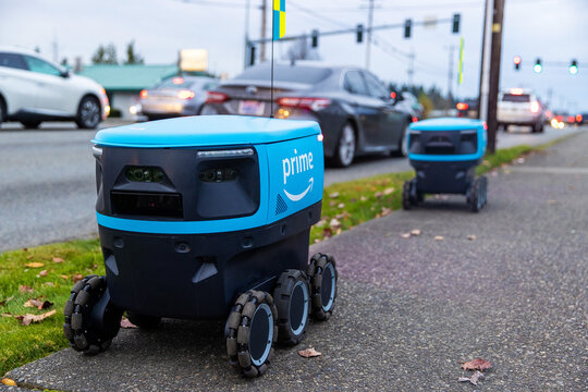 Everett, Washington, USA - November 24, 2021: Autonomous delivery robot Amazon Scout seen on sidewalk prepared to deliver packages with a fully electric delivery system in Everett, Washington.