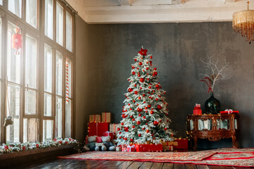 Christmas tree and gift boxes near the window. High quality photo