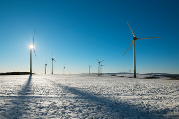 Wind turbine and blue sky in winter landscape