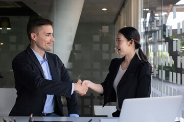 Businessman and partner handshake for the new agreement after sign in agreement contract with work together.
