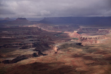The landscape  of dessert in the sunset with schrubs, and canyon and hills.