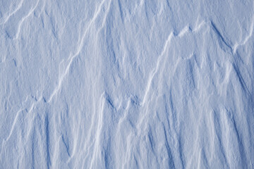 Natural snow background with drawings of mountains made by the w