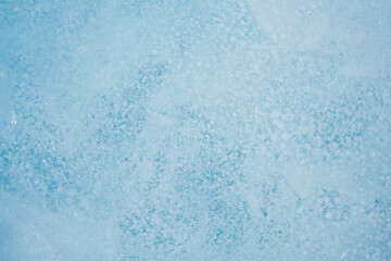Texture of winter ice surface. Blue natural ice background