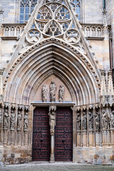 Gate at the entrance to Erfurt Cathedral and building facade in Germany