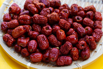 Chinese jujubes in round bamboo basket