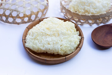Tremella Mushroom in bamboo basket on white background.