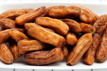 Sun-dried bananas on white background.