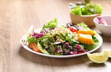 Fresh organic vegetables with quinoa salad on wooden background, Healthy Vegan food